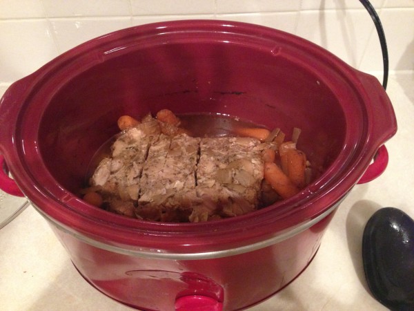 Cooked pork loin and carrots in a crock pot