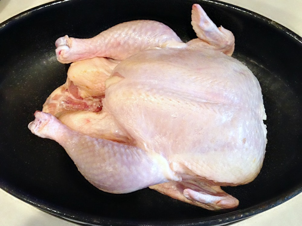 raw whole chicken in roasting pan