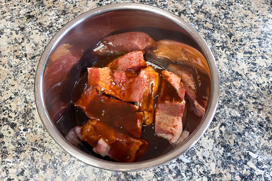 country style ribs in bowl of instant pot with barbecue sauce
