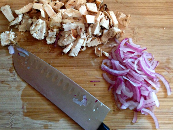 chicken and red onion prepped on cutting board