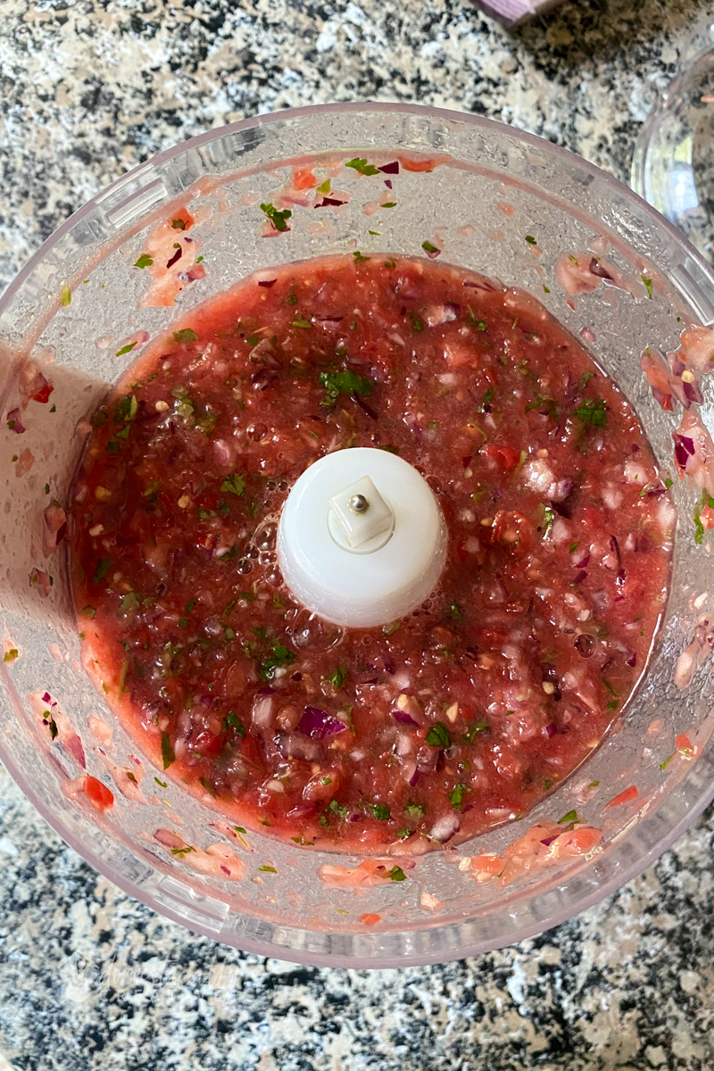 finished salsa processed in the bowl of a food processor