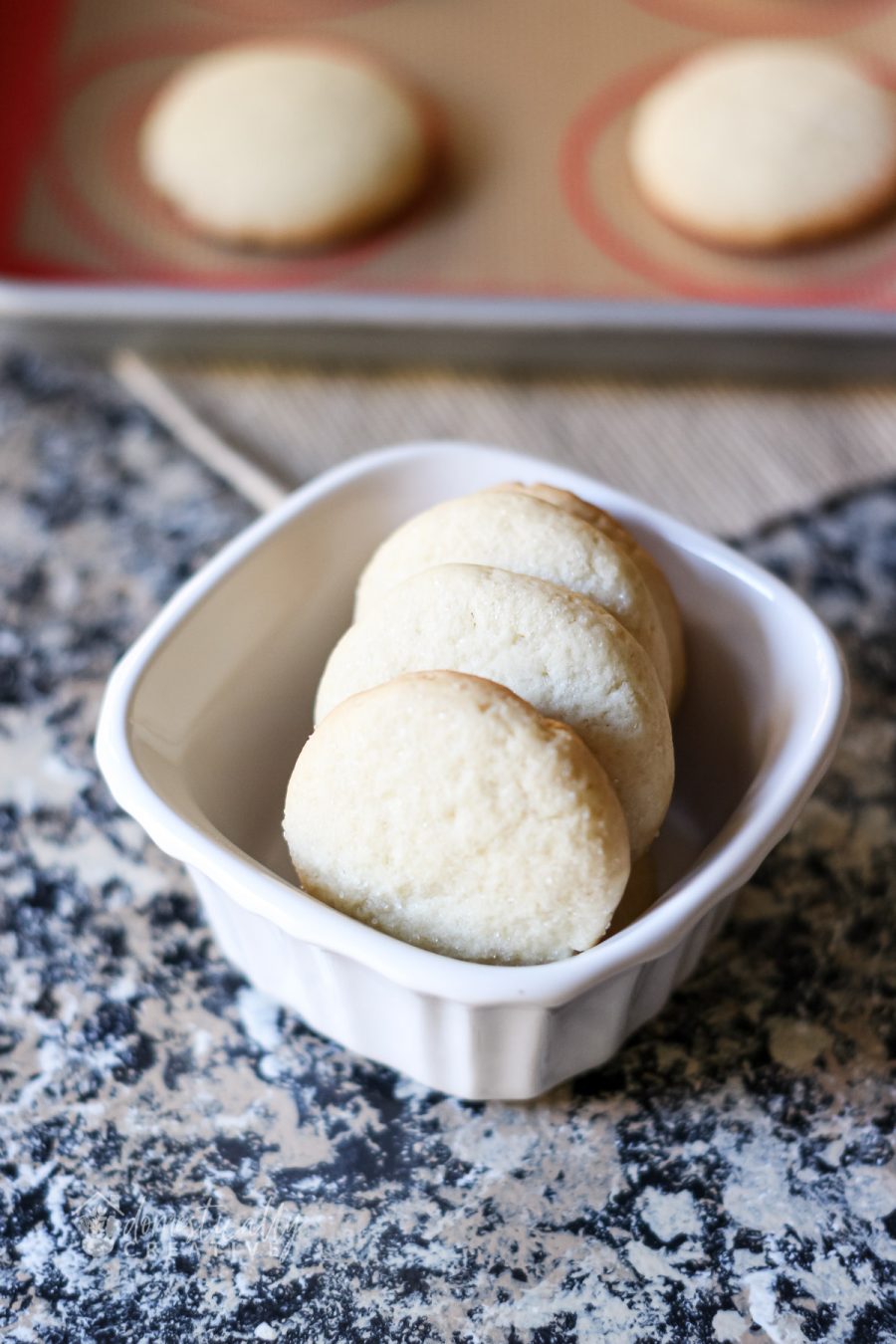 Close up sugar cookies in small white container