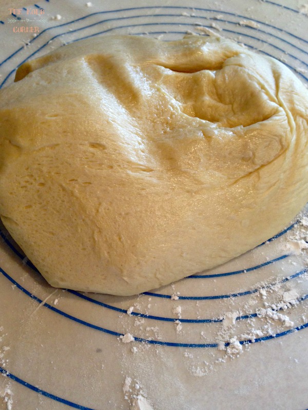 dinner roll dough turned out onto a floured surface to roll