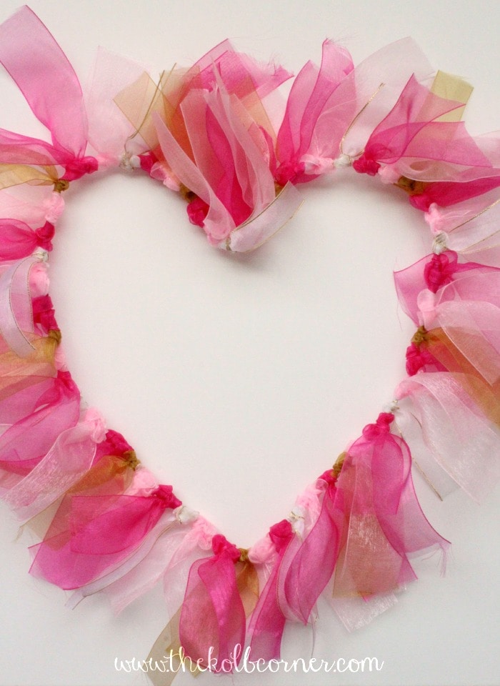 Finished wire wreath form with tied on ribbon in varying shades of pink