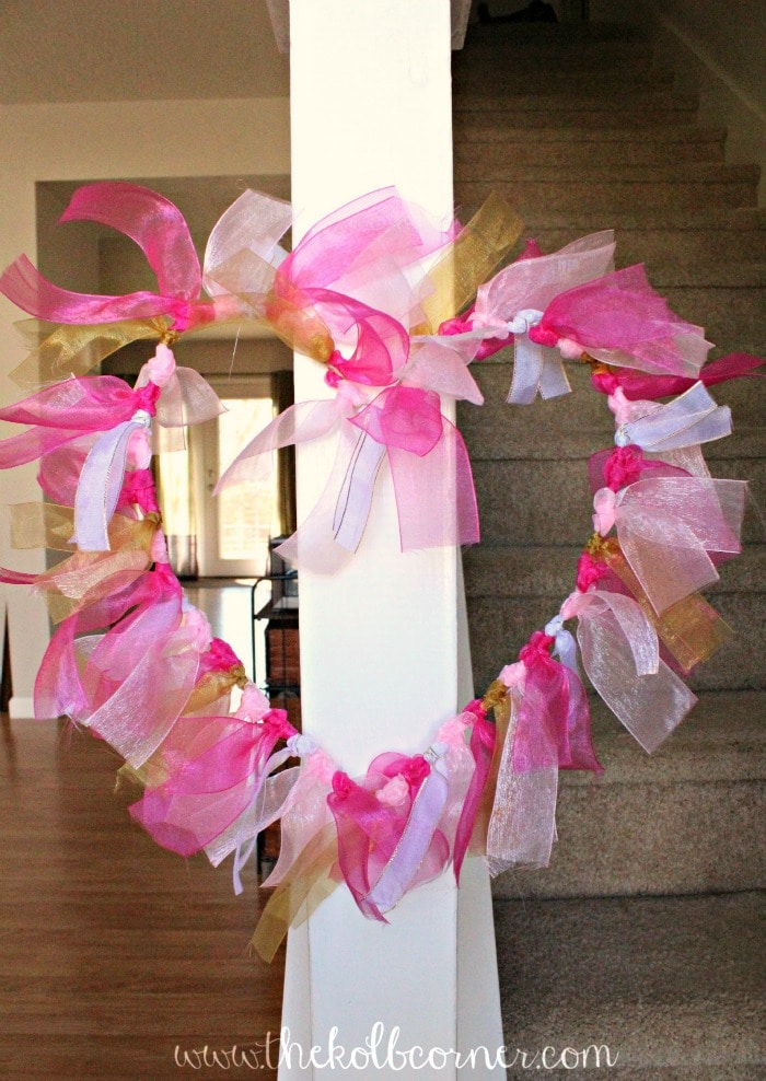 Finished ribbon wreath hanging on staircase ballaster