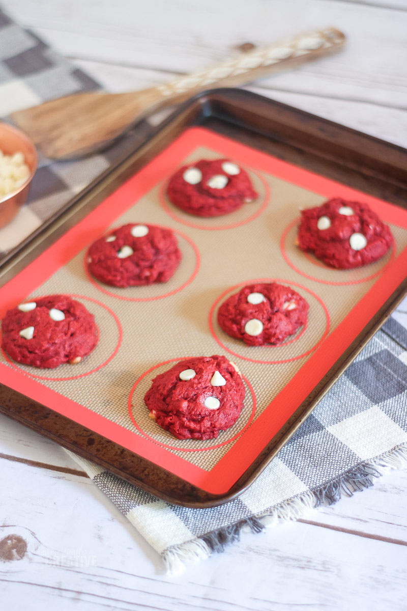 red velvet cookies laying on baking sheet