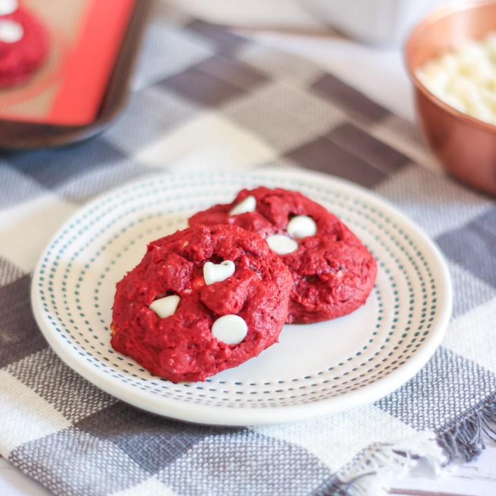 Red Velvet White Chip Cookies on plate with more cookies in the background