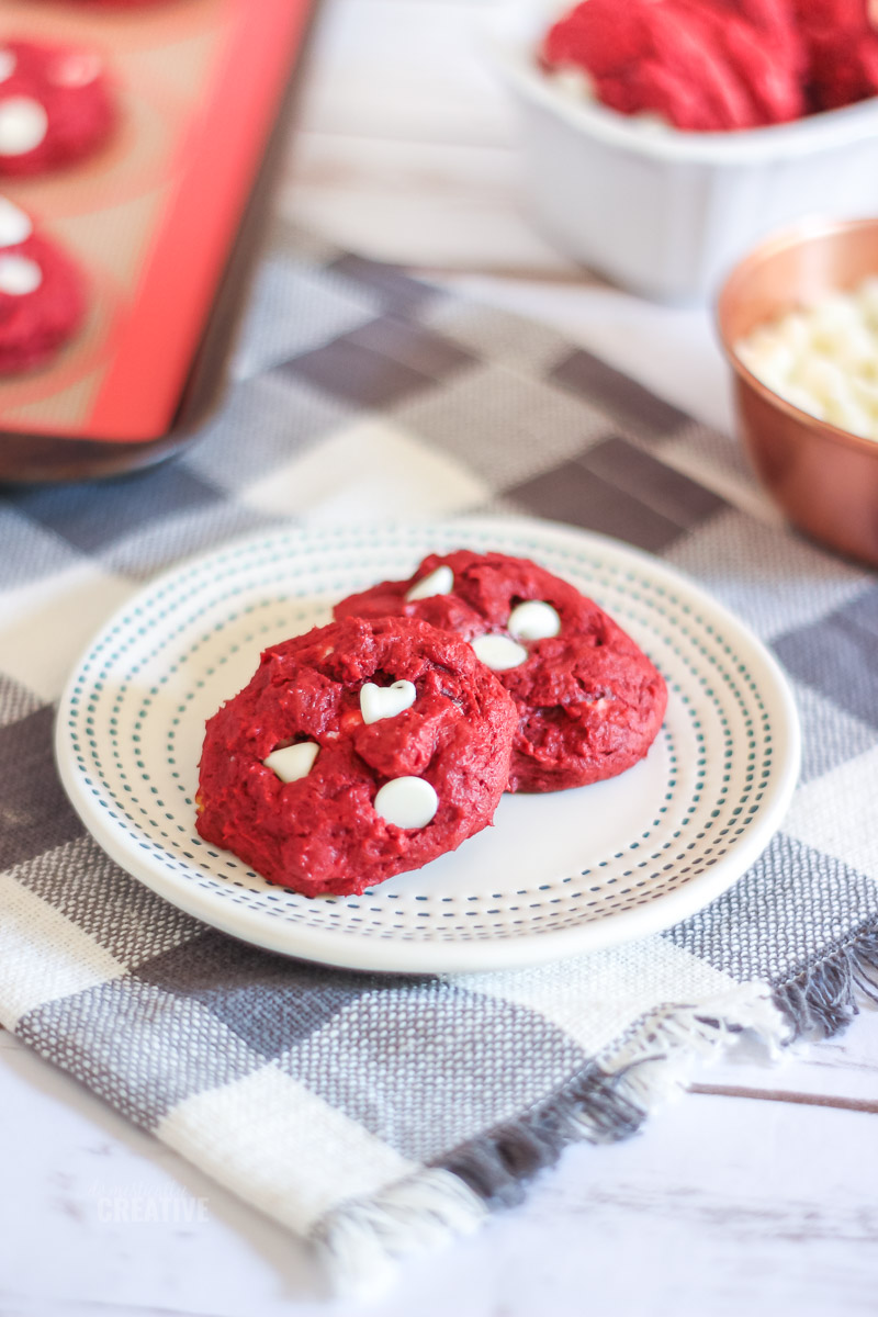 Red Velvet White Chip Cookies on plate with more cookies in the background