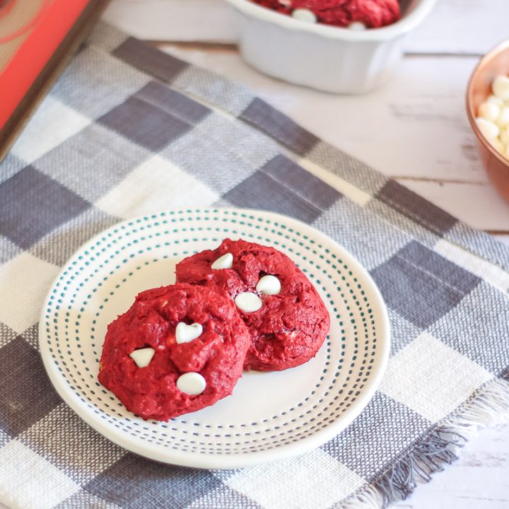 Red Velvet White Chip Cookies on plate with more cookies in the background