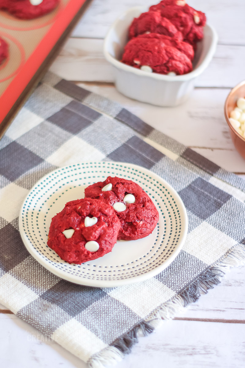 Red Velvet White Chip Cookies on plate with more cookies in the background