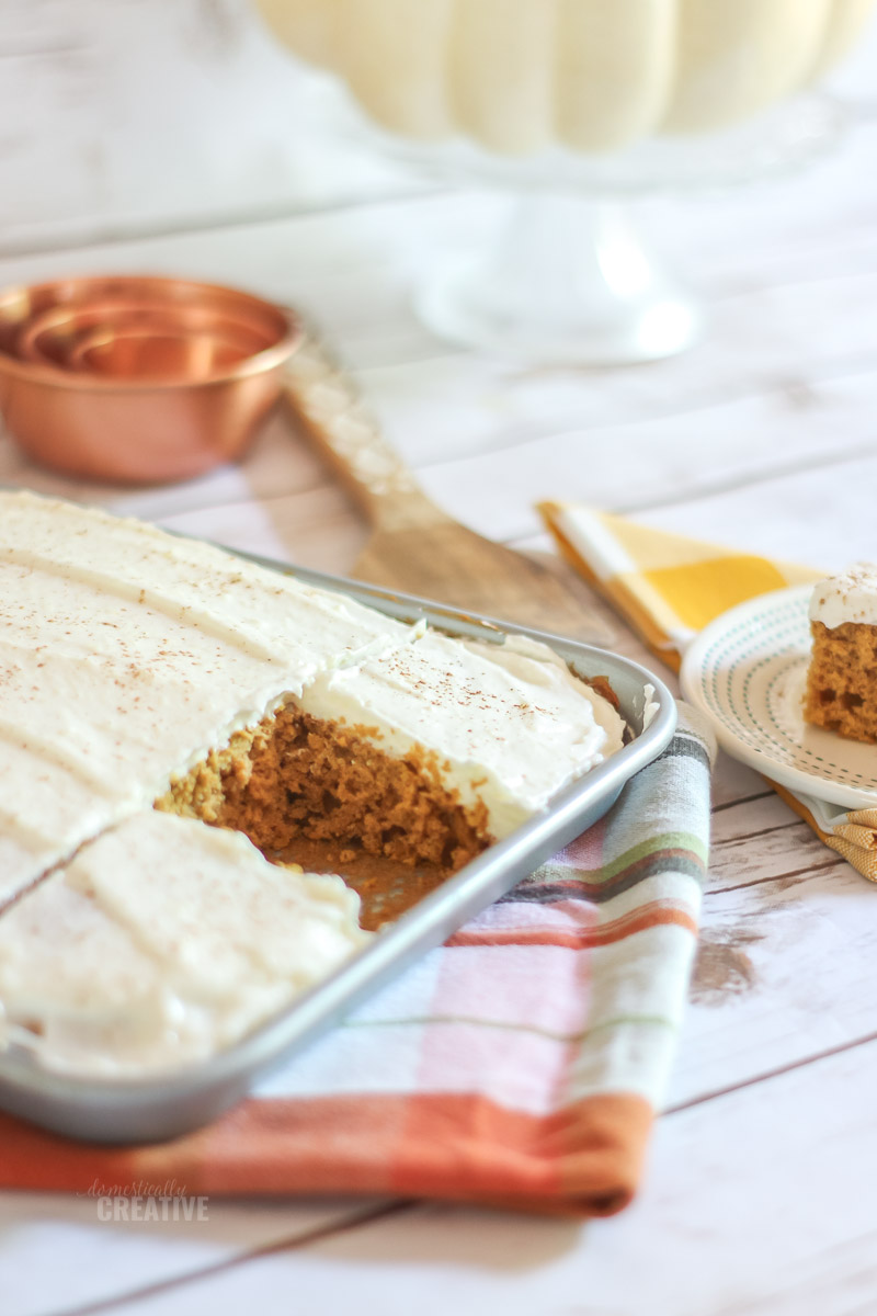 pumpkin bars in a pan with one cut out and on a plate