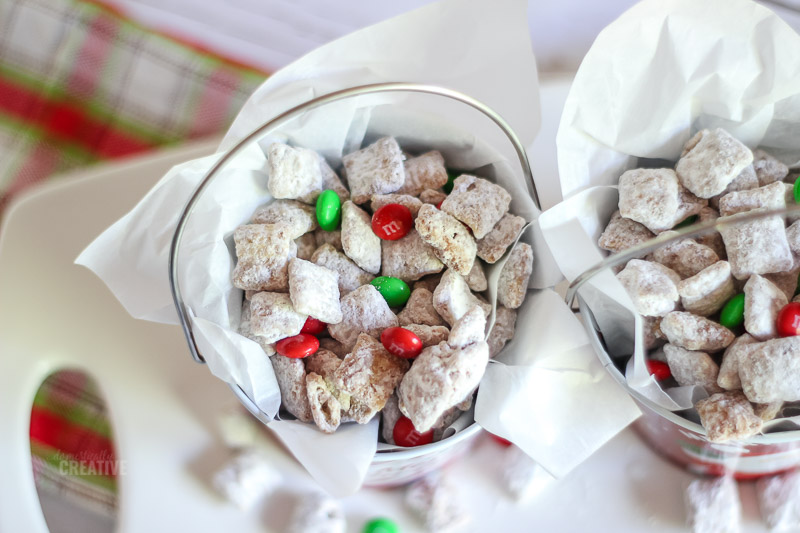 Overhead muddy buddies in Christmas tins with red and green m&ms