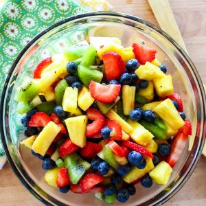 A rainbow blend of fruit, combined with a sweet and tart dressing makes this honey lime fruit salad a sure to be hit at any Summer cookout.