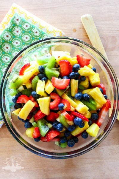 A rainbow blend of fruit, combined with a sweet and tart dressing makes this honey lime fruit salad a sure to be hit at any Summer cookout.