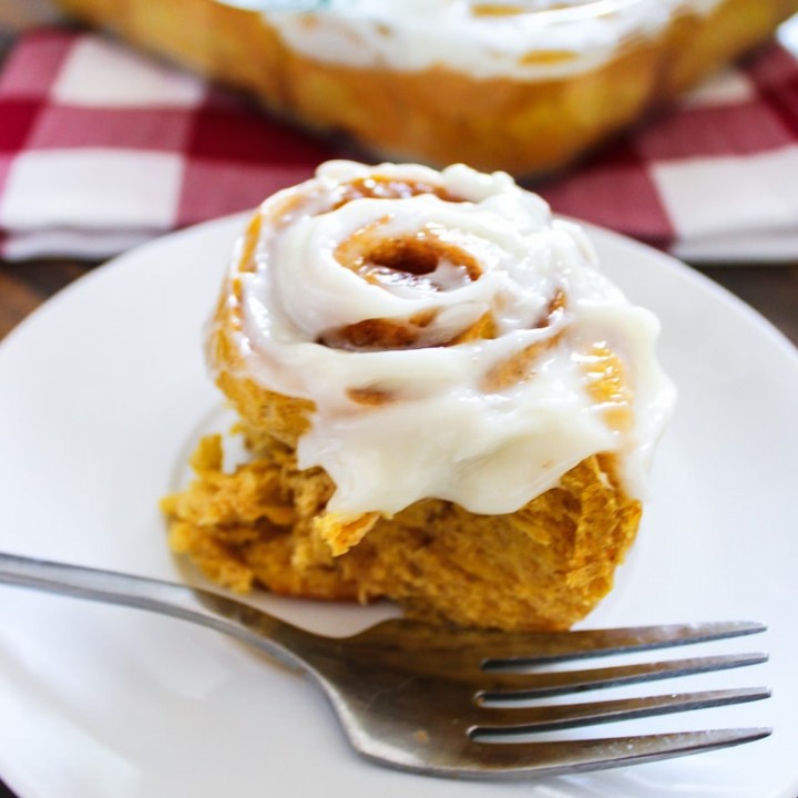 Warm, gooey pumpkin cinnamon rolls, topped with a sweet cream icing are the perfect pairing to large hot cup of coffee.