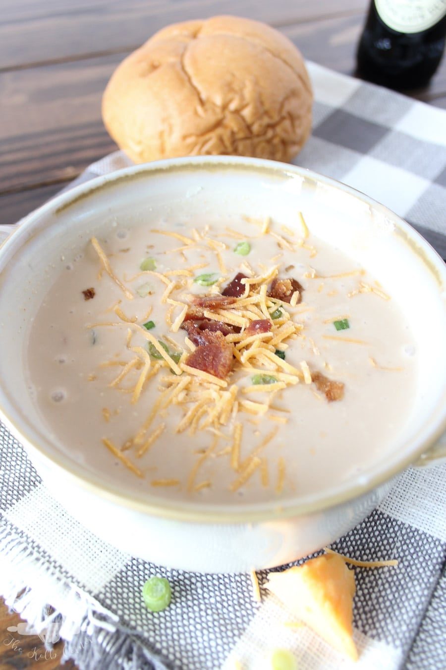 close up of soup with bacon and cheese on top