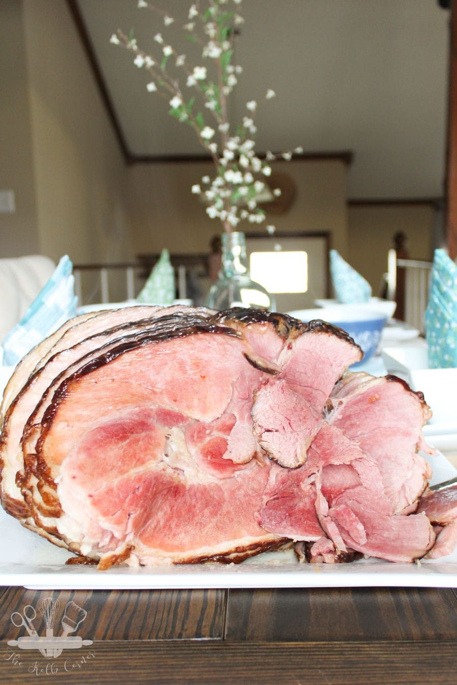 Ham styled with a beautiful Easter tablescape behind it