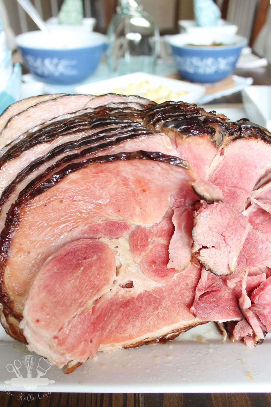 Ham styled with a beautiful Easter tablescape behind it