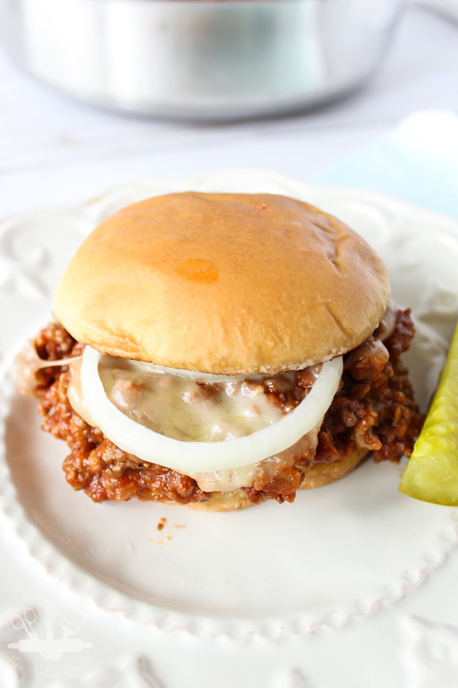 Close up of sloppy joe meat on top of a toasted bun