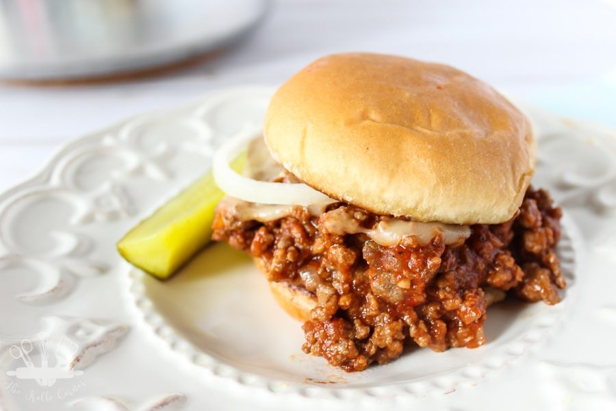 Homemade sloppy joe meat sauce on a toasted bun with pickle and onion