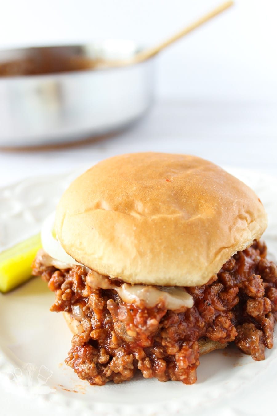 Sloppy joe sandwich with saute pan in the background