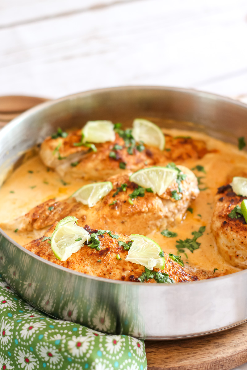 Close up skillet chicken in a cheesy chili lime sauce