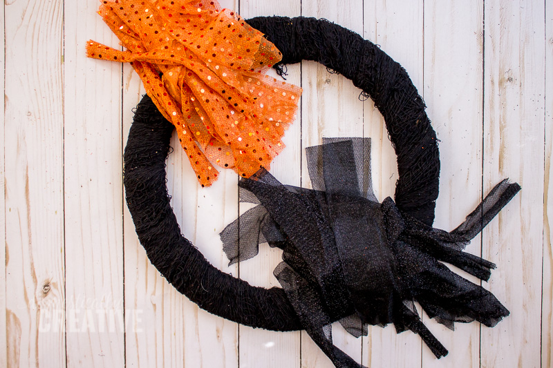 I am totally picking up the supplies for this Halloween fabric scrap wreath from the dollar store!