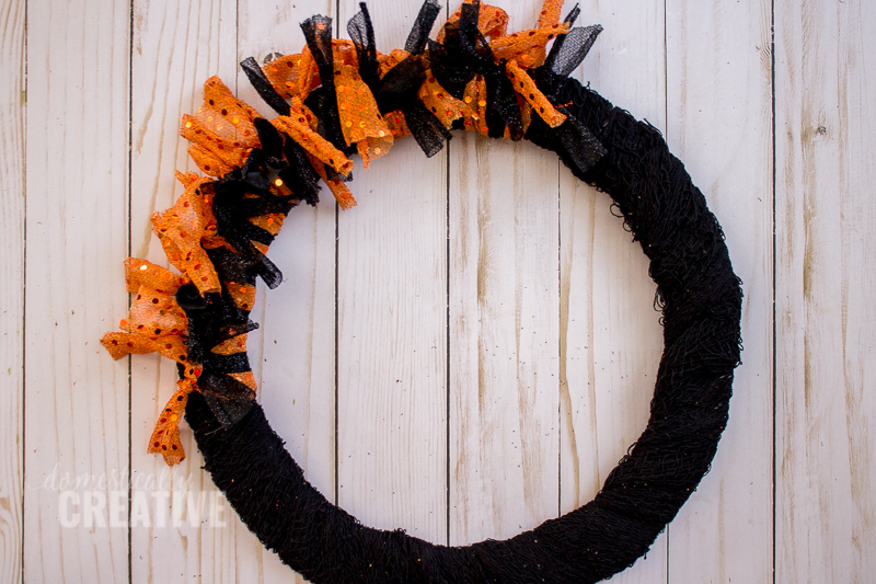 I am totally picking up the supplies for this Halloween fabric scrap wreath from the dollar store!