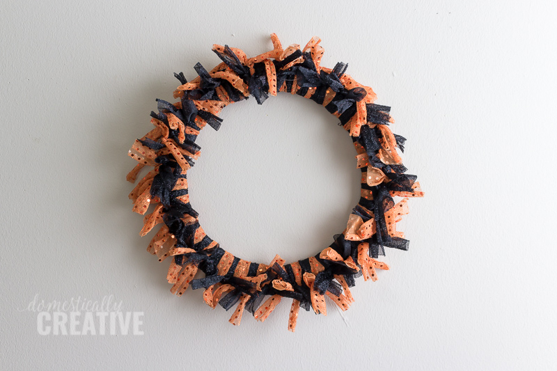 I am totally picking up the supplies for this Halloween fabric scrap wreath from the dollar store!