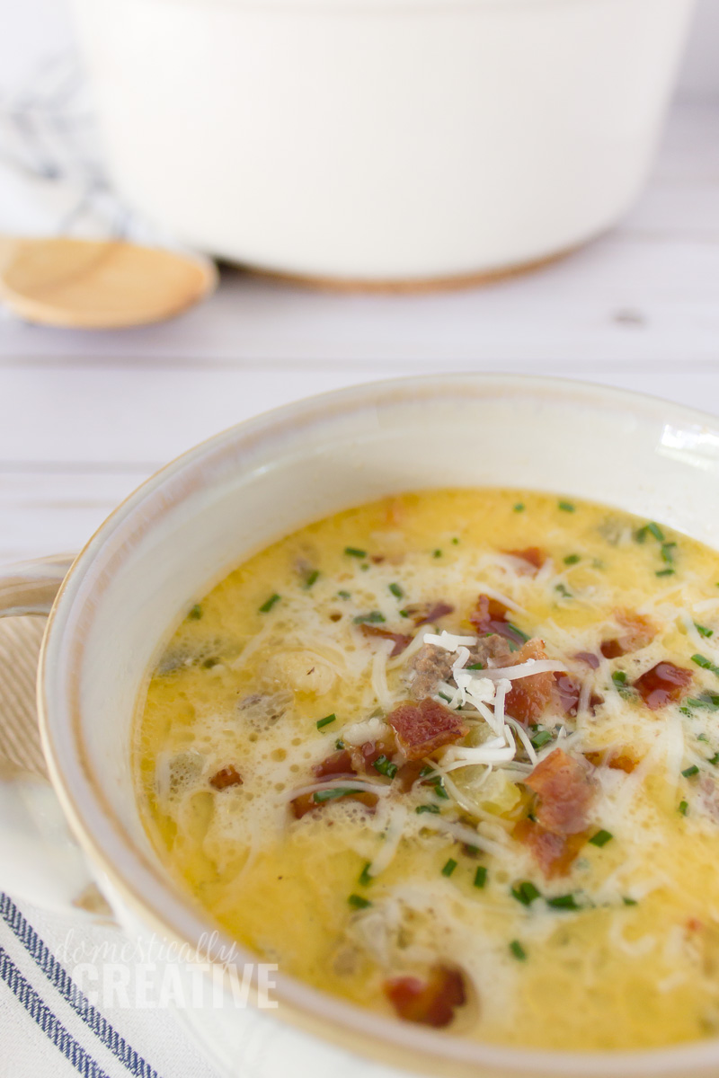 close up of bacon and cheese on top of creamy soup
