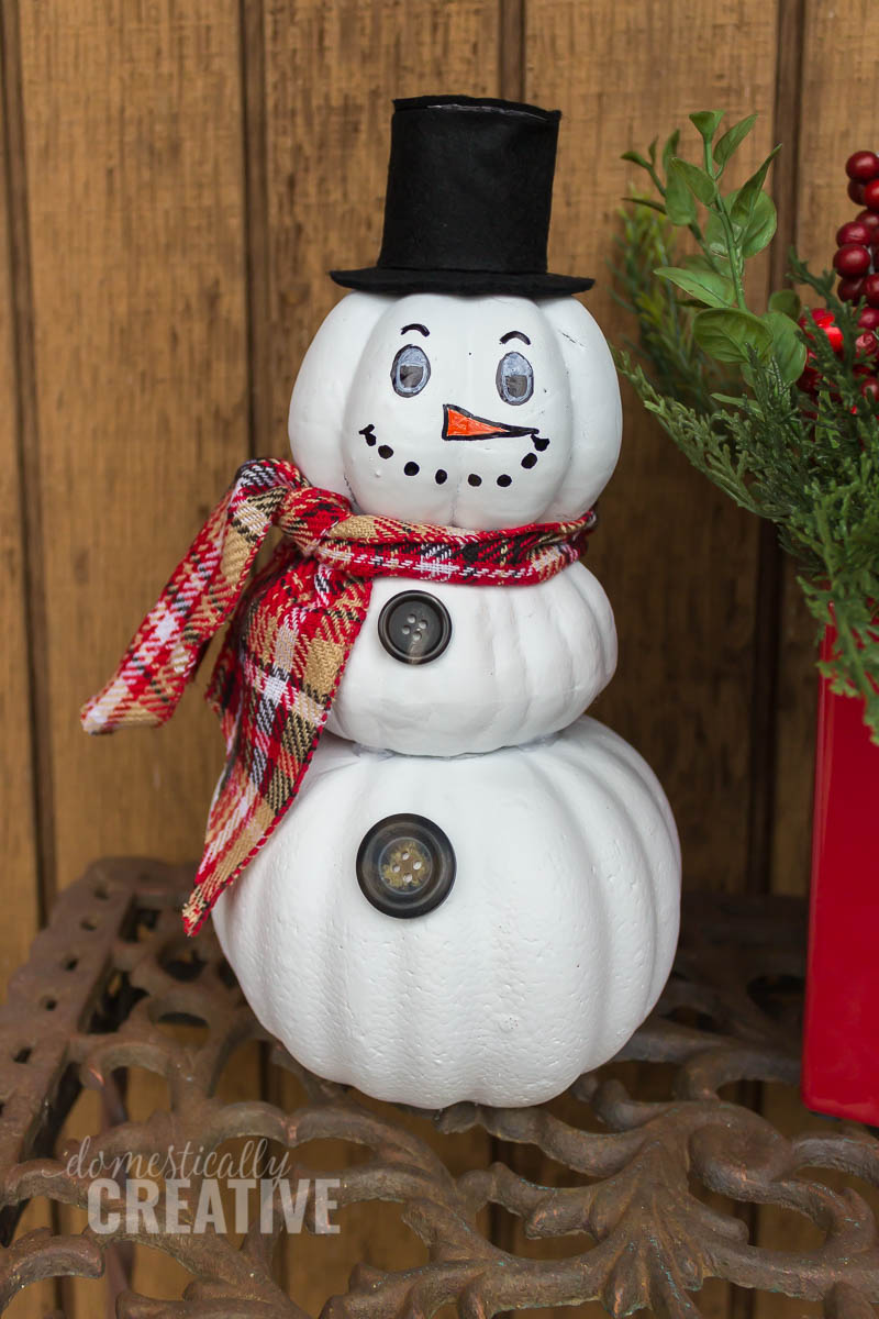 Turn your Fall decor into Winter decor and make this easy upcycled pumpkin snowman from fake foam pumpkins! #12daysofChristmas #snowmancraft #pumpkinsnowman #upcycledsnowman #upcycledcraft