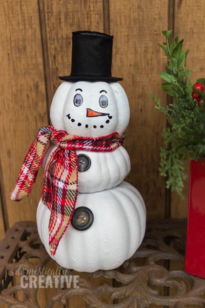 Turn your Fall decor into Winter decor and make this easy upcycled pumpkin snowman from fake foam pumpkins! #12daysofChristmas #snowmancraft #pumpkinsnowman #upcycledsnowman #upcycledcraft