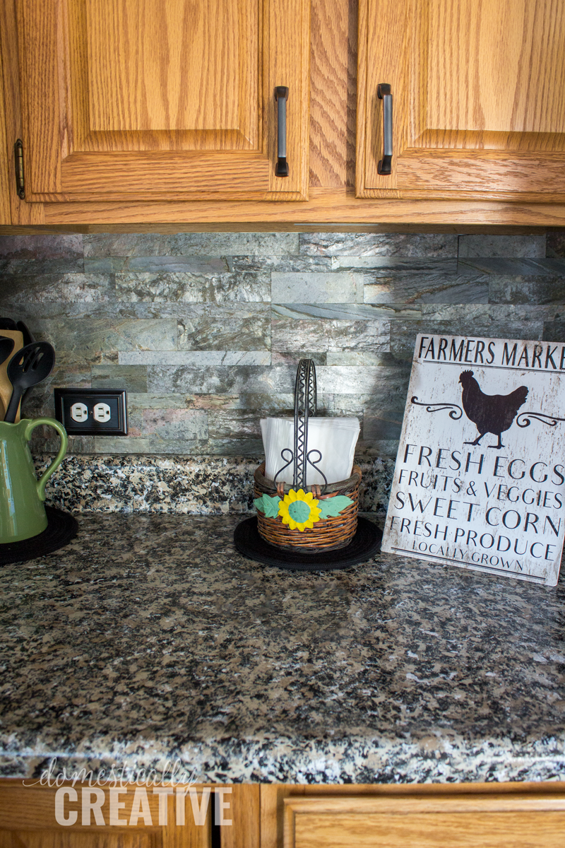 close up painted counters with aspect peel and stick stone backsplash