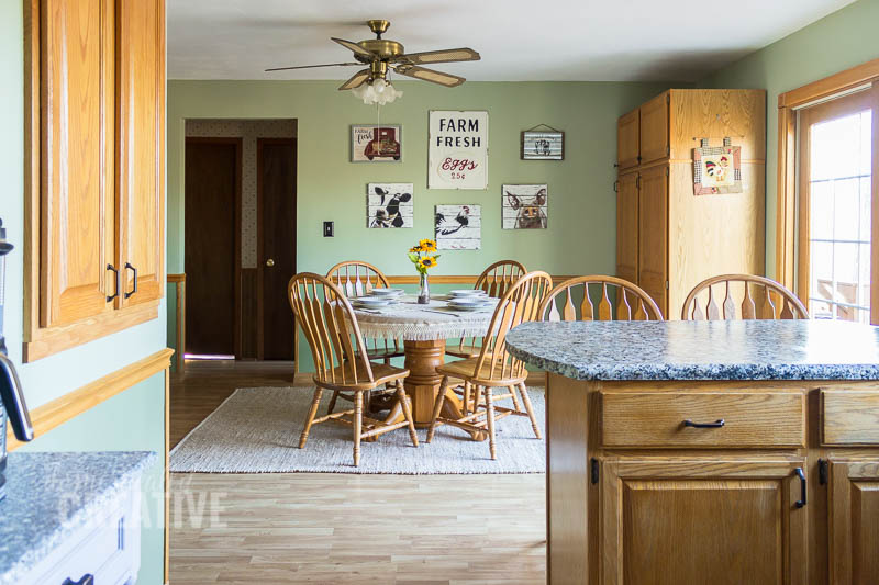 view of kitchen looking into dining room with green walls