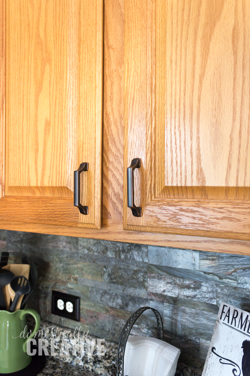 close up of liberty hardware on oak cabinets