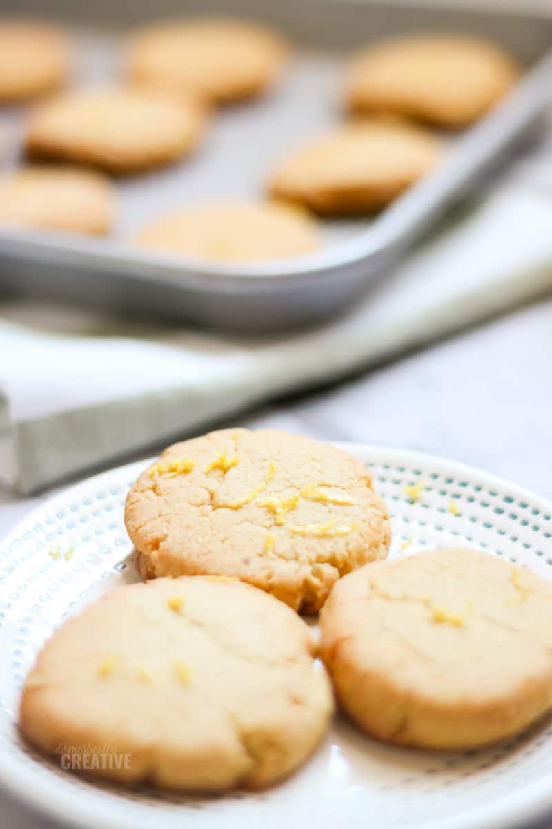 Close up lemon cookies with baking sheet in blurred background