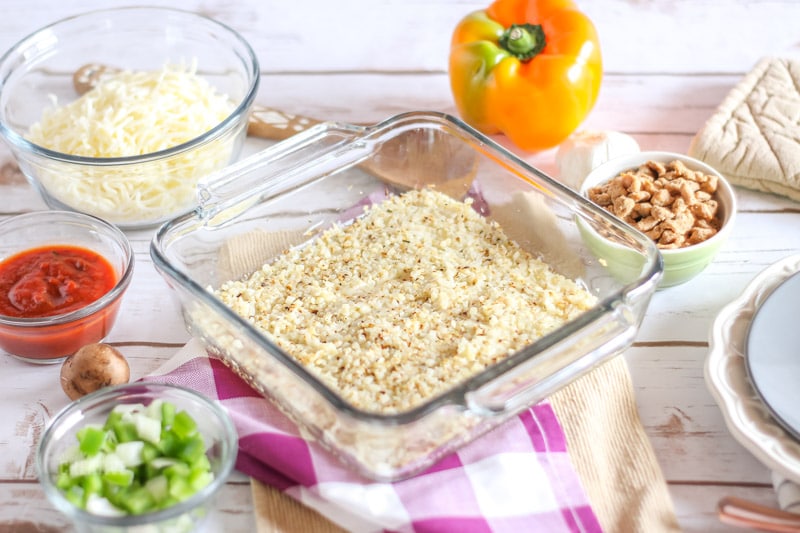 Push cauliflower crust into casserole dish