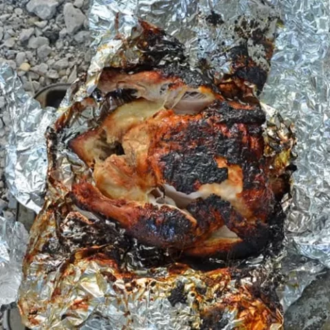 Image for How to Make a Roasted Chicken Over a Campfire Recipe