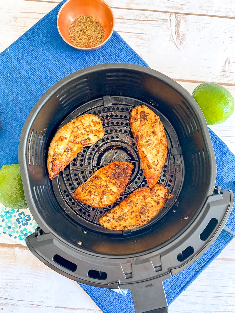 birds eye view of finished chicken tenders in air fryer basket