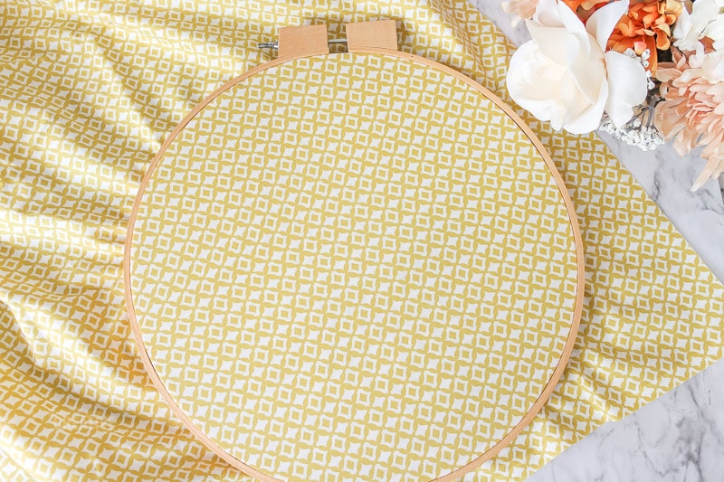 yello fabric placed in embroidery hoop