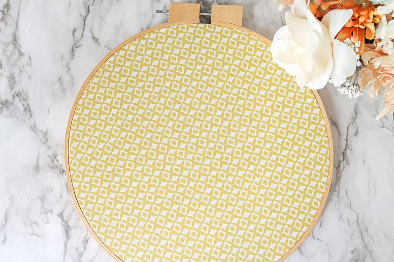 excess yellow fabric trimmed away from embroidery hoop