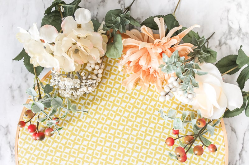 flower stems arranged on top of hoop