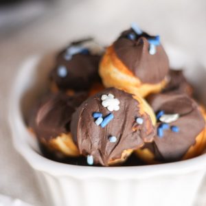 Close up chocolate dipped donut bites with sprinkles