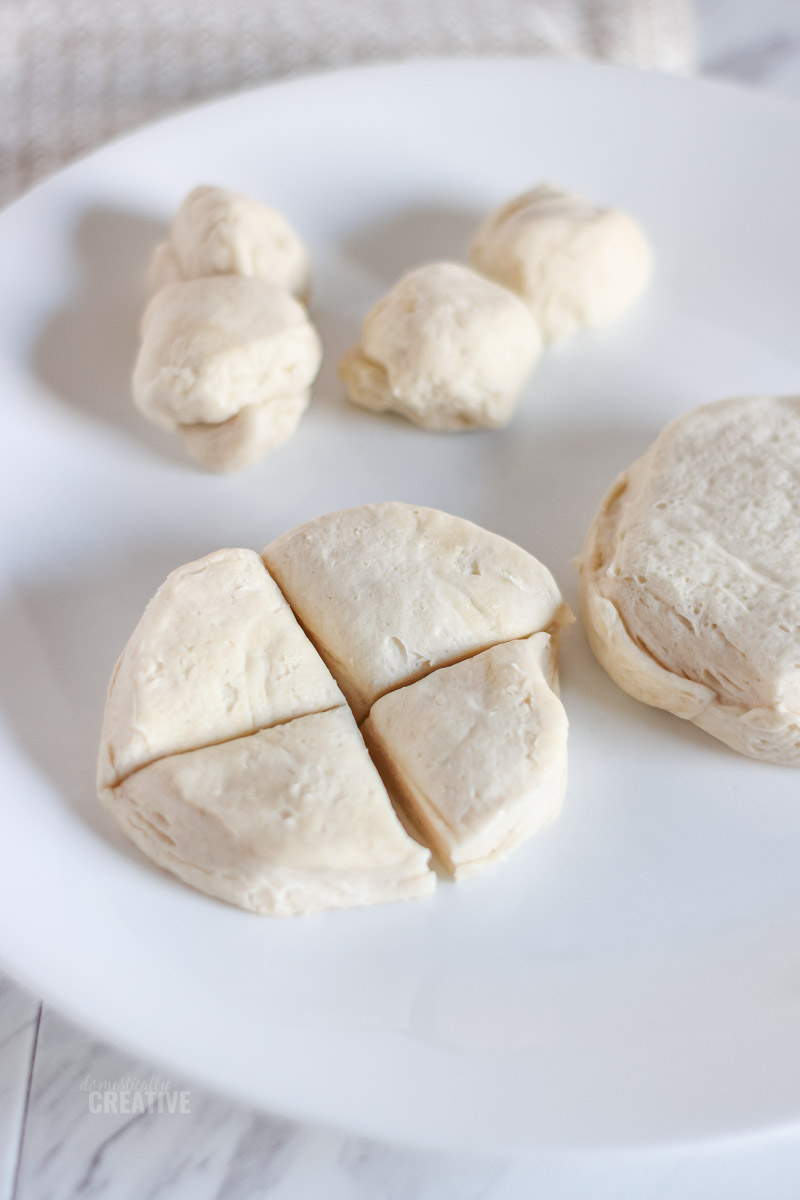 Closeup of biscuit dough cut into sections and rolled into balls