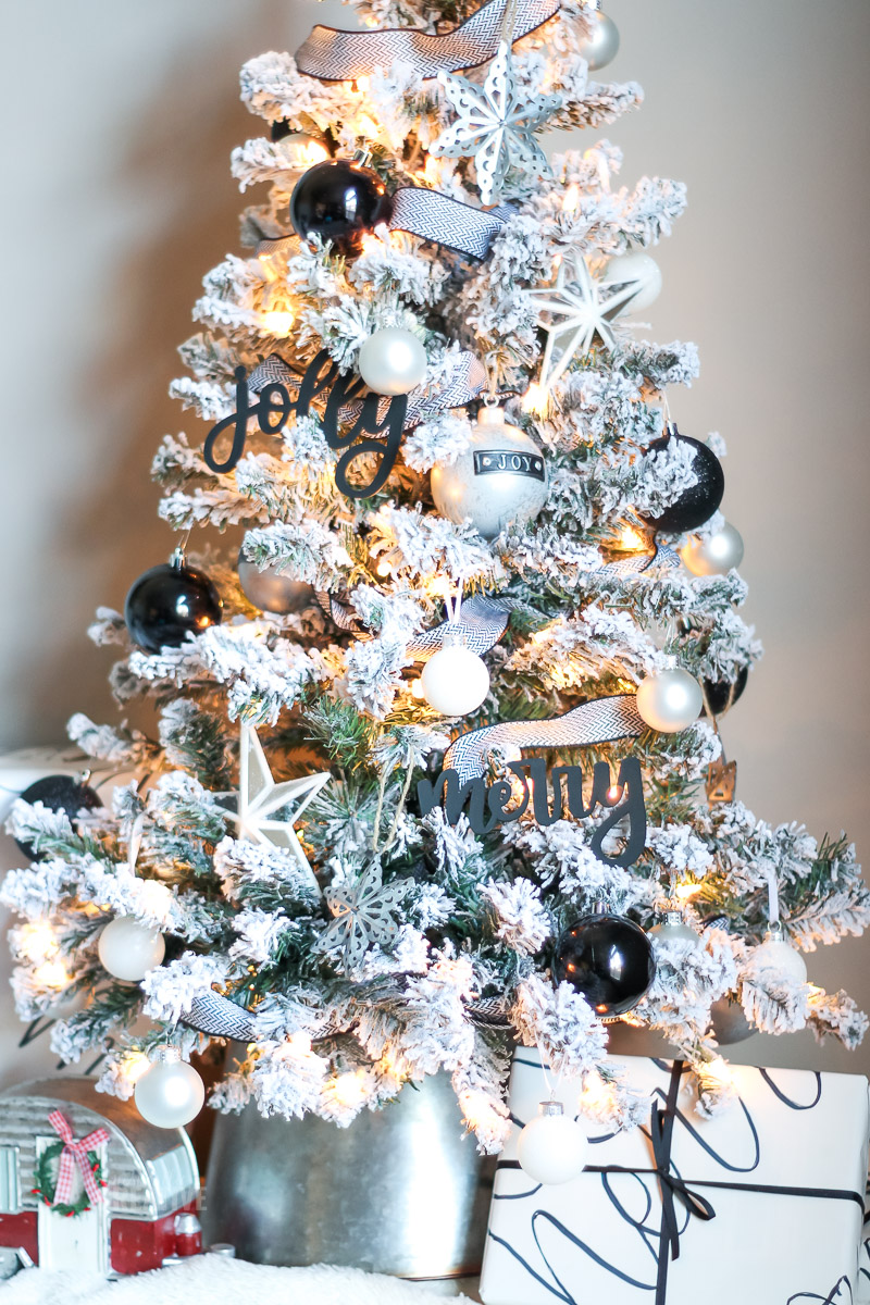 Flocked tabletop Christmas tree with black and white ornaments