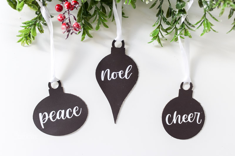 Leather ornaments on white table with greenery