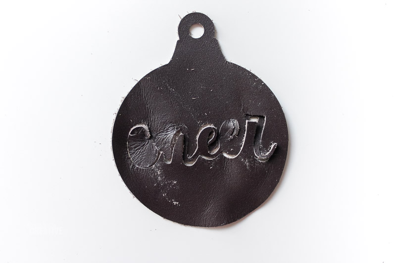 "Cheer" Badly cut out of leather ornament