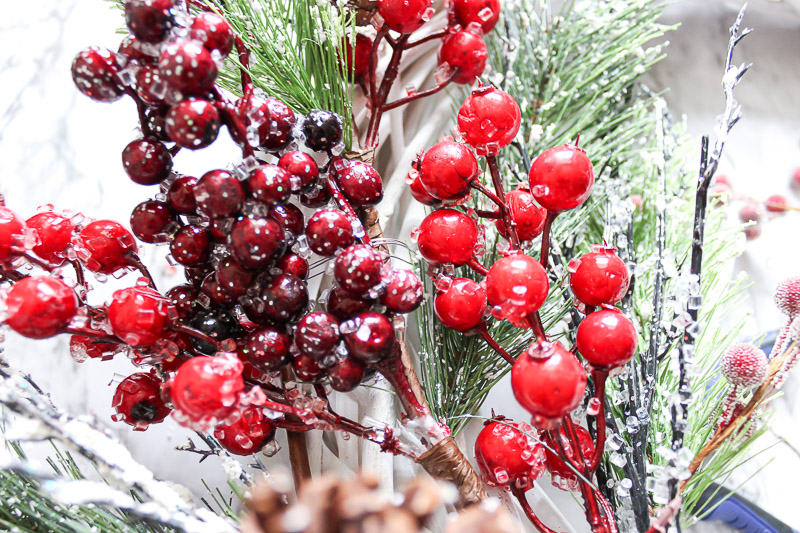 Close up of floral stems attached to wreath form with floral wire