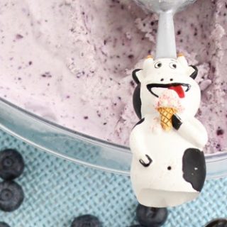 Lemon and blueberry ice cream with cow spoon