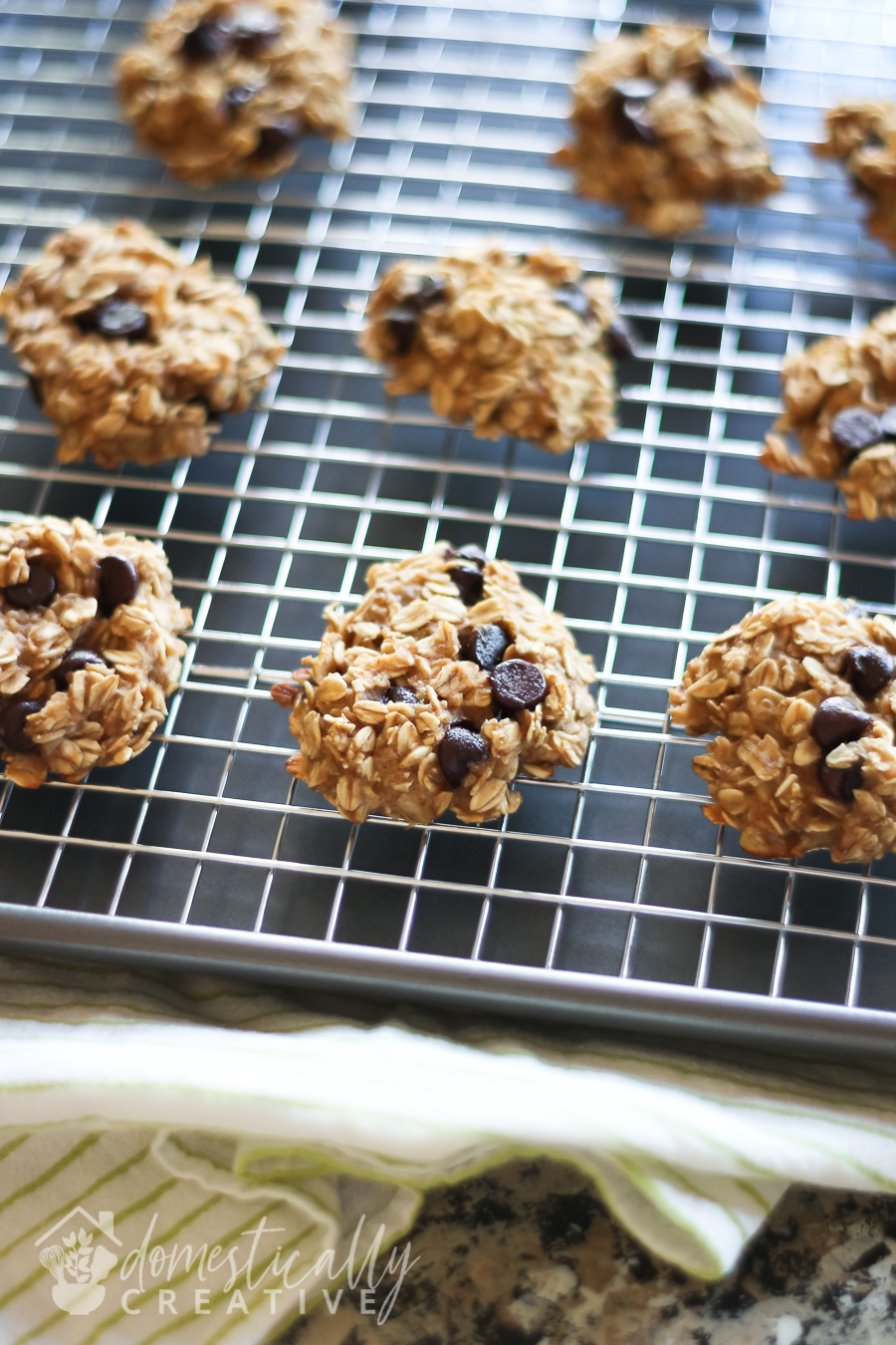 fresh from the oven chocolate chip banana oat cookies close up cooling on a wire rack